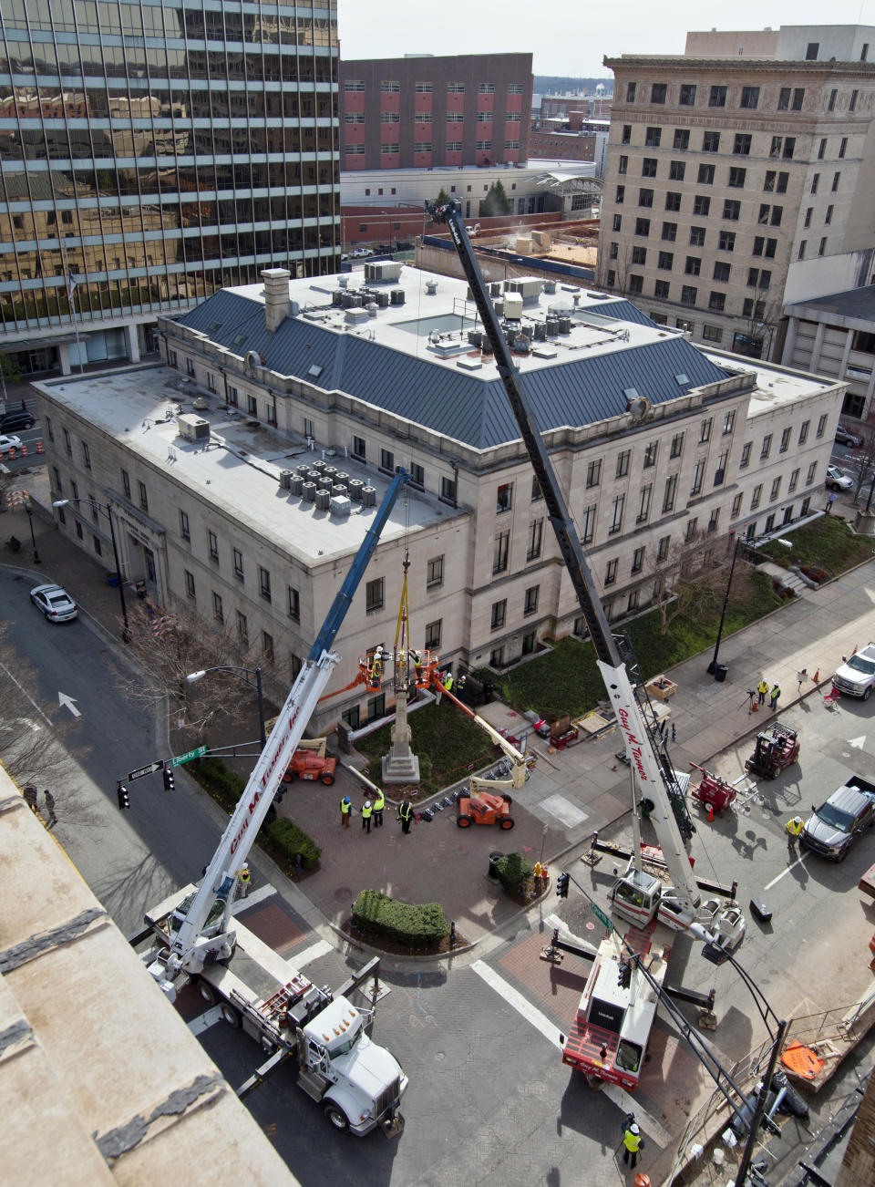 FILE - Workers from Guy M Turner, Inc. prepare to lift the soldier figure from the top of the Confederate monument at the corner of Fourth and Liberty streets on Tuesday, March 12, 2019. The statue stood in front of what used to be the Forsyth County Courthouse but is now a residential building. On Friday, Dec. 16, 2022, North Carolina's Supreme Court ruled that the local chapter of United Daughters of the Confederacy lacks standing to challenge the city of Winston-Salem's removal of the Confederate monument on private property, but it can refile a future lawsuit making similar arguments. (Walt Unks/Winston-Salem Journal via AP, File)