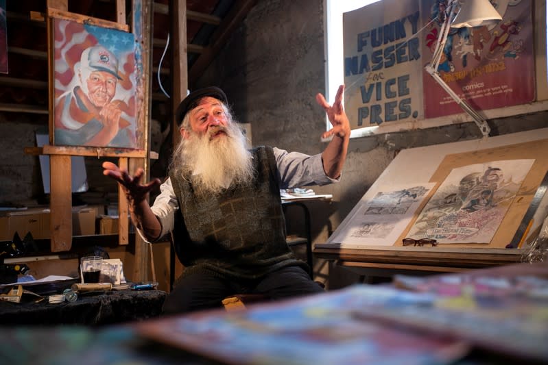 FILE PHOTO: Michael Netzer, 63, an American comic artist formerly named Mike Nasser, gestures as he speaks during his interview with Reuters in his attic studio at his home in the Israeli settlement of Ofra in the occupied West Bank