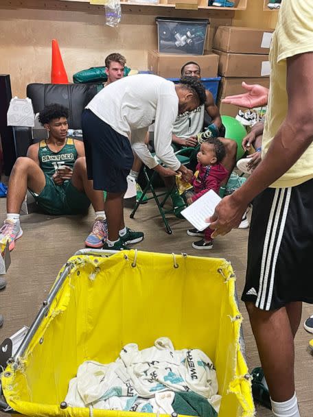 PHOTO: Aiden Webster, the son of Saint Leo University assistant basketball coach Ashley Webster, is pictured alongside the university's men's basketball team. (Pam Randall)