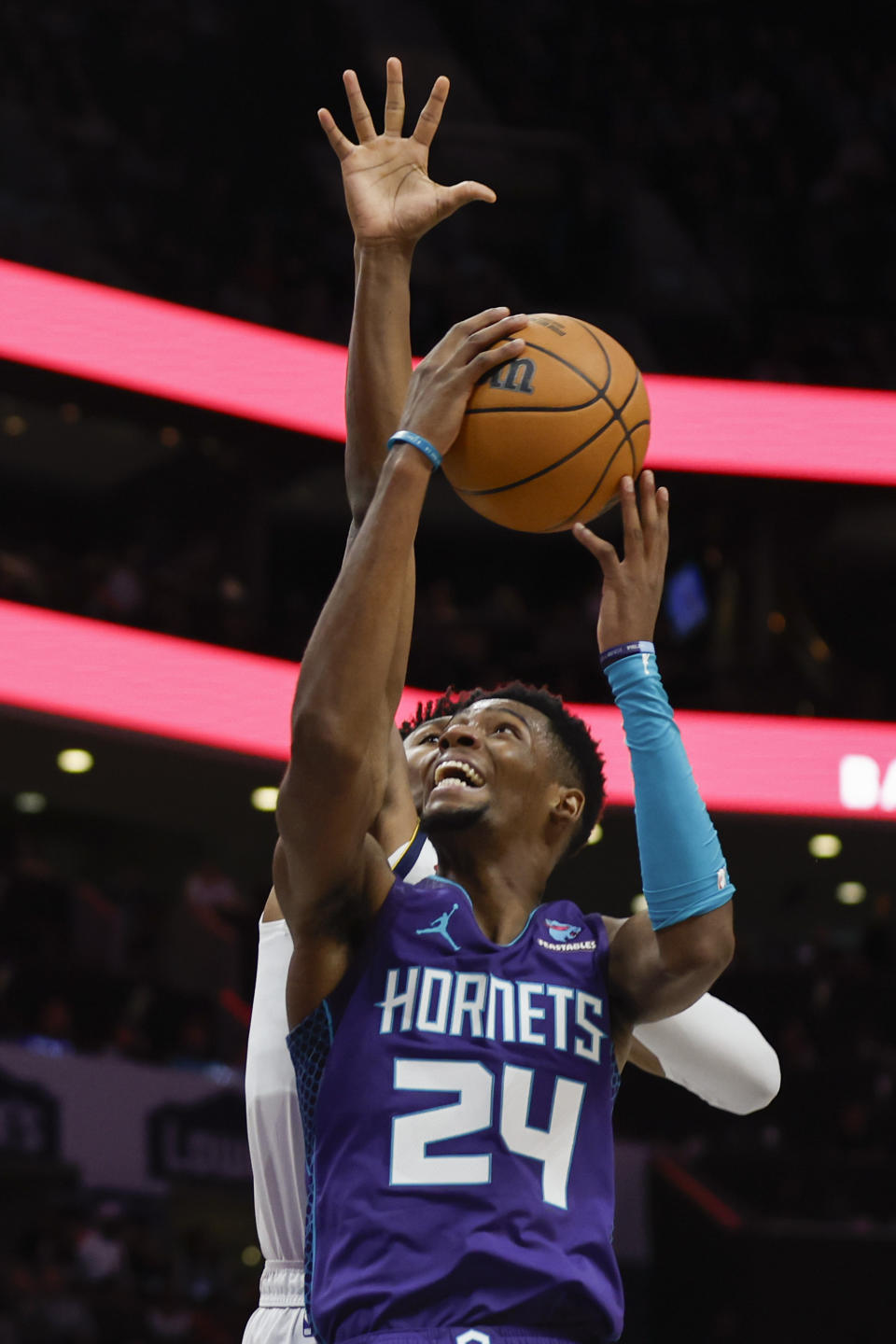 Charlotte Hornets forward Brandon Miller (24) drives to the basket against Denver Nuggets forward Peyton Watson during the first half of an NBA basketball game in Charlotte, N.C., Saturday, Dec. 23, 2023. (AP Photo/Nell Redmond)