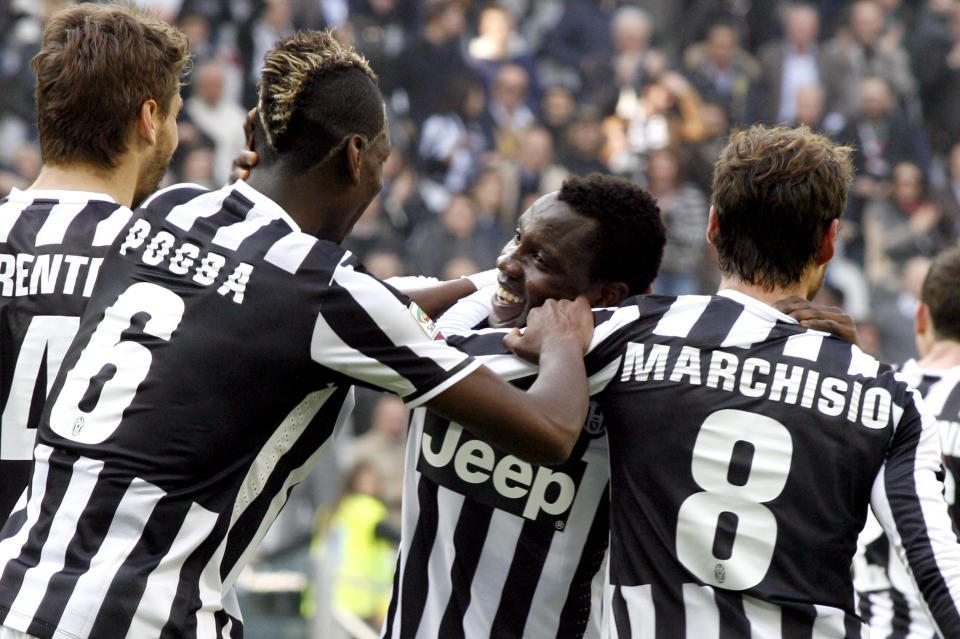 Juventus midfielder Kwadwo Asamoah, center of Ghana, celebrates after scoring during a Serie A soccer match between Juventus and Fiorentina at the Juventus stadium, in Turin, Italy, Sunday, March 9, 2014. (AP Photo/Massimo Pinca)