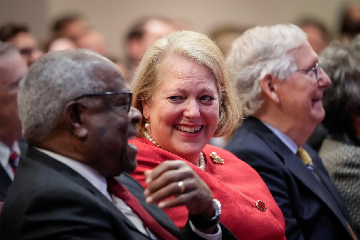 (L-R) Associate Supreme Court Justice Clarence Thomas sits with his wife and conservative activist Virginia Thomas while he waits to speak at the Heritage Foundation on October 21, 2021 in Washington, DC. 