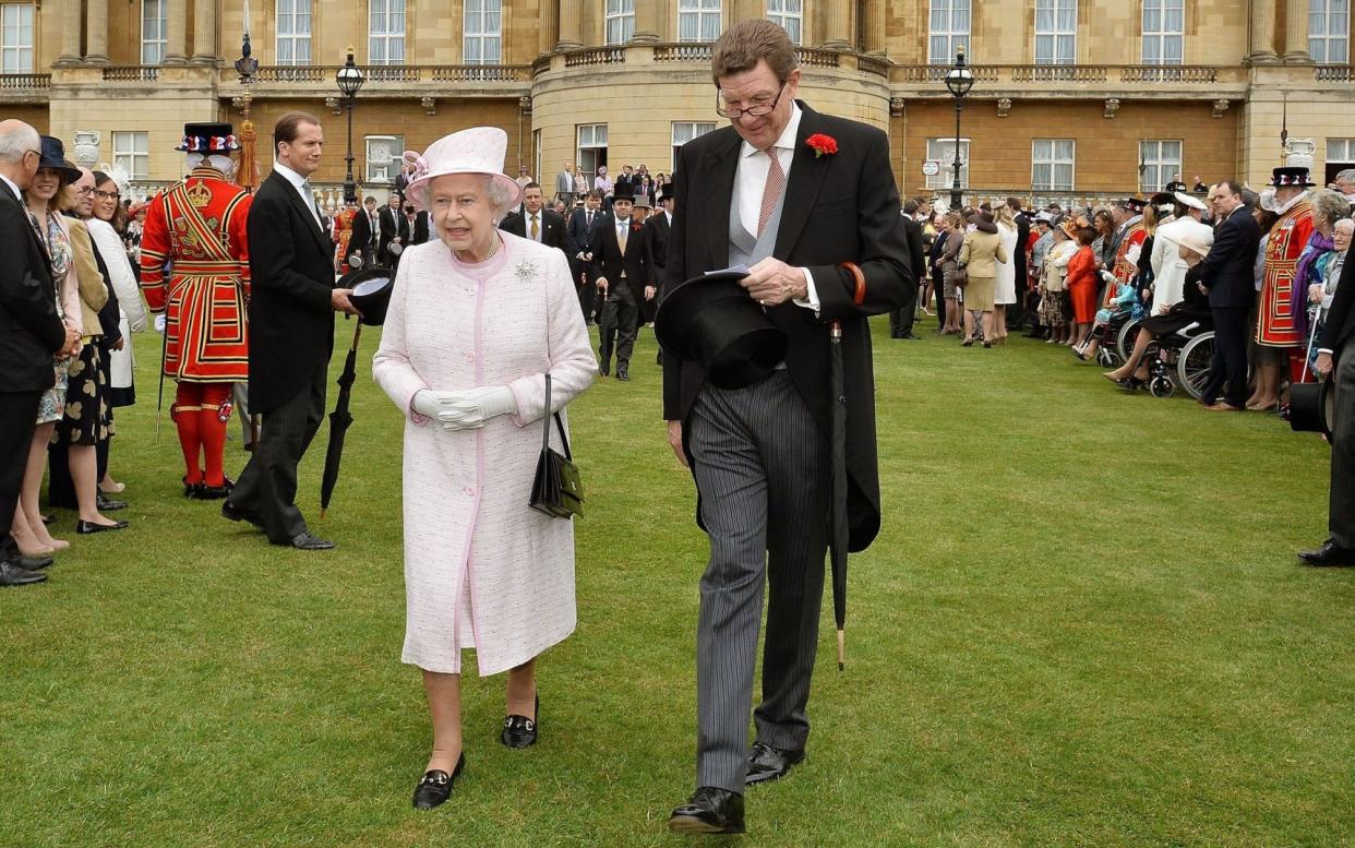 Queen Elizabeth II alongside the Lord Chamberlain, the Earl Peel, in 2013 - PA