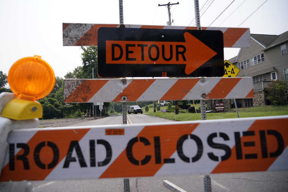 A roadblock is seen as crews search for a a pair of missing children swept away after weekend rains, Monday, July 17, 2023, in Washington Crossing, in Upper Makefield Township, Pa. (AP Photo/Matt Slocum)