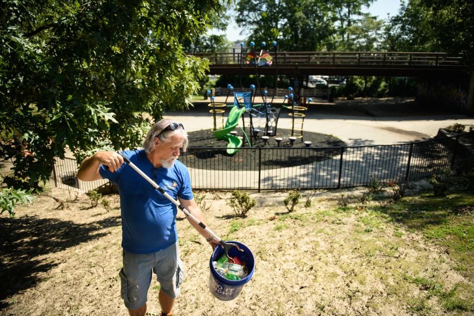 Cool Spring Downtown District Ambassador Mark Dodd picks up some trash at a park along Anderson Street in downtown Fayetteville on Tuesday, July 11, 2023. Parks and Recreation Director Michael Gibson said Wednesday that there is little the city can do about littering.