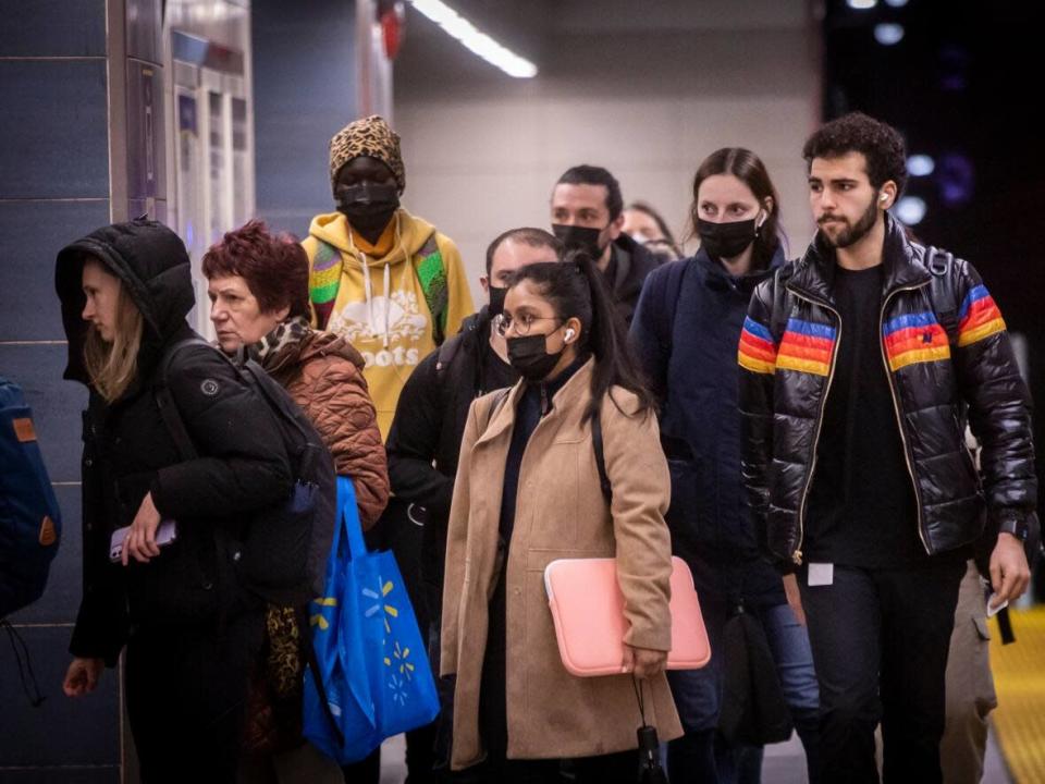 Transit riders are pictured at the Vancouver City Centre SkyTrain station on March 14, 2022. (Ben Nelms/CBC - image credit)
