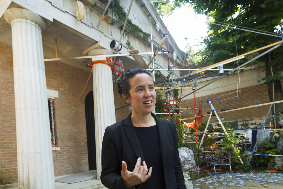 In this photo taken Wednesday, May 29, 2013, artist Sarah Sze is interviewed outside the United States Pavilion during a preview of the 55th edition of the Venice Biennale of Arts in Venice, northern Italy. (AP Photo/Domenico Stinellis)