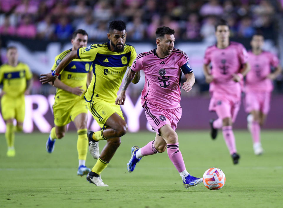 Inter Miami forward Lionel Messi races ahead of Nashville SC midfielder Anibal Godoy during the first half of a CONCACAF Champions Cup soccer match Wednesday, March 13, 2024, in Fort Lauderdale, Fla. (AP Photo/Michael Laughlin)