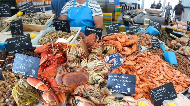 Fishmonger presenting fresh seafood