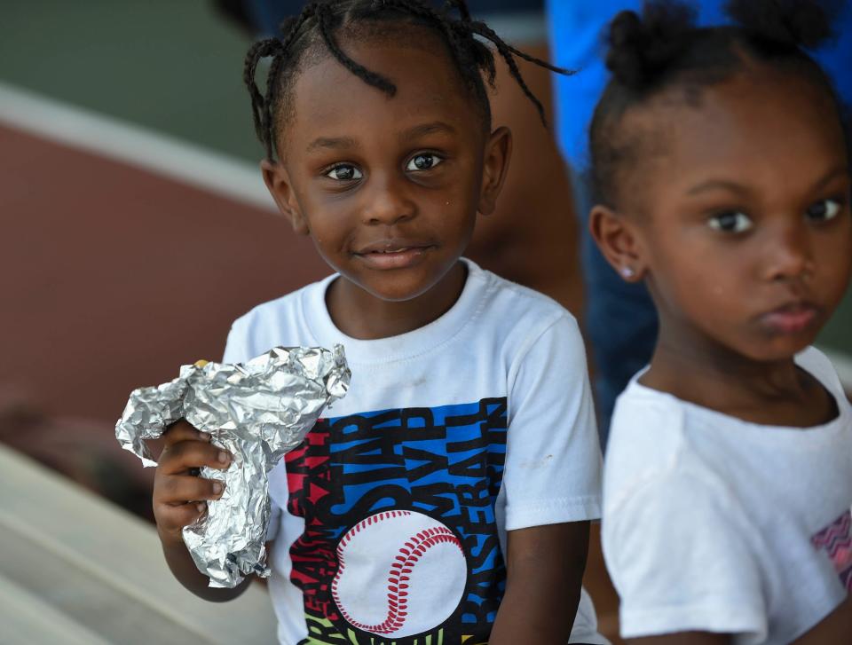 Children, parents, and other attendees take part of the Juneteenth Celebration of Freedom, festivities under the pavilion at the 10th Street Community Center on Saturday, June 18, 2022, in Stuart, Florida.
