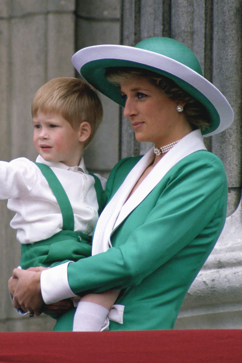 <p>In a green-and-white wide-brimmed hat while holding son Prince Harry at the Trooping of the Colour.</p>