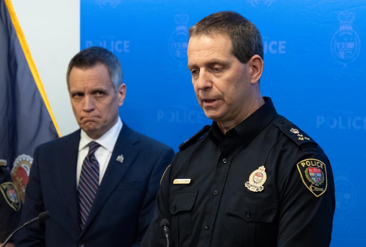 Ottawa Mayor Mark Sutcliffe looks on as Ottawa police Chief Eric Stubbs responds to a question during a news conference the day after six people, including a mother and her four children, were killed in Barrhaven. (Adrian Wyld/The Canadian Press - image credit)