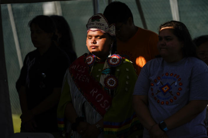 Young people from the Rosebud Sioux Tribe pray during a ceremony at the U.S. Army's Carlisle Barracks, in Carlisle, Pa., Wednesday, July 14, 2021. The disinterred remains of nine Native American children who died more than a century ago while attending a government-run school in Pennsylvania were headed home to Rosebud Sioux tribal lands in South Dakota on Wednesday after a ceremony returning them to relatives. (AP Photo/Matt Rourke)