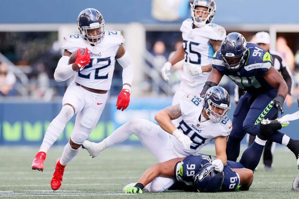 Derrick Henry #22 of the Tennessee Titans carries the ball against the Seattle Seahawks during third quarter at Lumen Field on September 19, 2021 in Seattle, Washington.