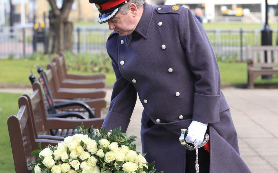 David Pearson, Deputy Lieutenant for West Yorkshire lays a wreath of 200 white roses at the Sir Tom Moore memorial plaque in Keighley, West Yorkshire -  Danny Lawson/PA