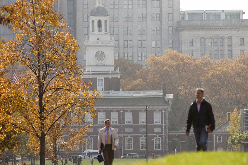 In this Nov. 12, 2014, file photo, people walk in view of Independence Hall in Philadelphia. AP File Photo/MATT ROURKE