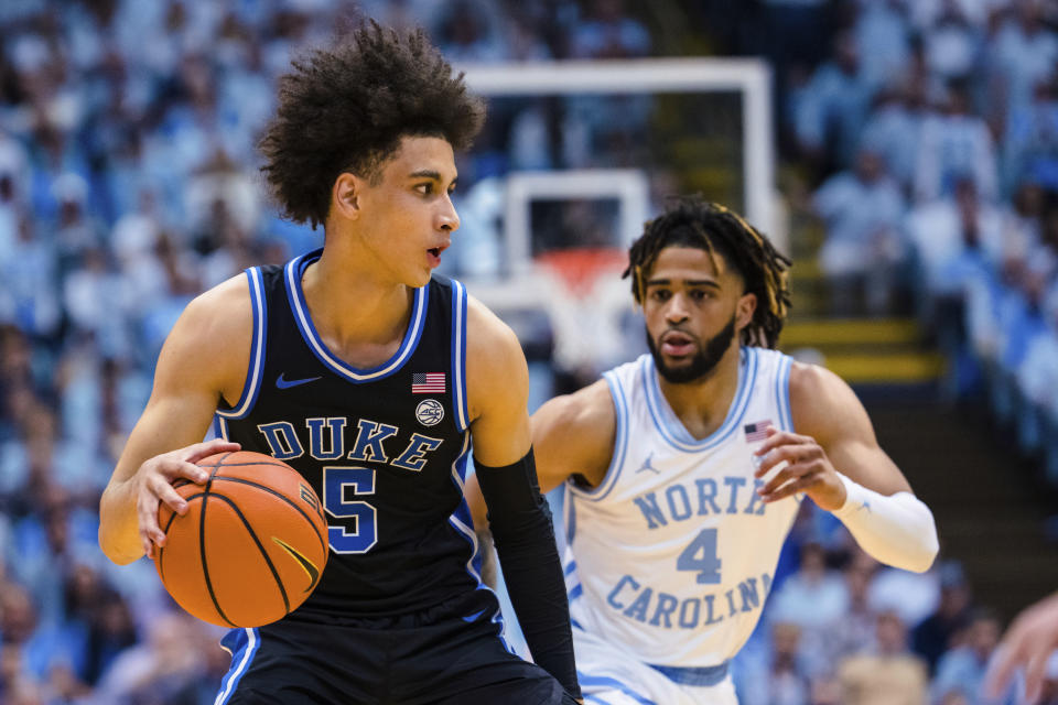 Duke guard Tyrese Proctor (5) is defended by North Carolina guard R.J. Davis (4) during the first half of an NCAA college basketball game Saturday, March 4, 2023, in Chapel Hill, N.C. (AP Photo/Jacob Kupferman)
