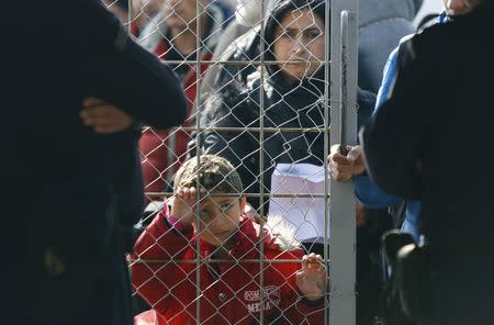 Migrants wait to enter Macedonia from Greece near Gevgelija, Macedonia, February 19, 2016. REUTERS/Ognen Teofilvovski