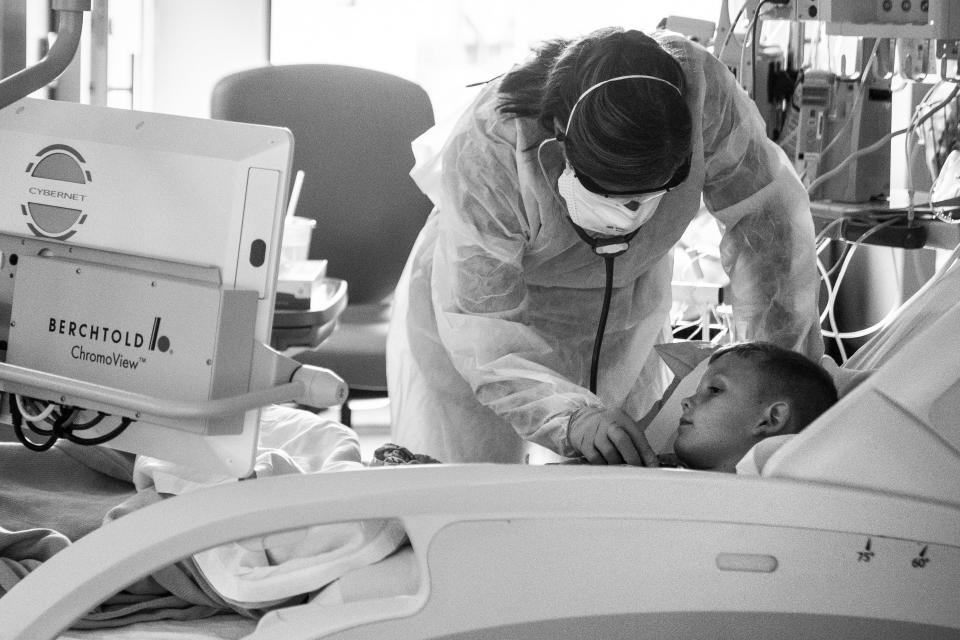 Nurse Kristen Brown cares for 6-year-old Jaxon Philiph, of Cedar Rapids. Jaxon was in the PICU after contracting COVID-19.