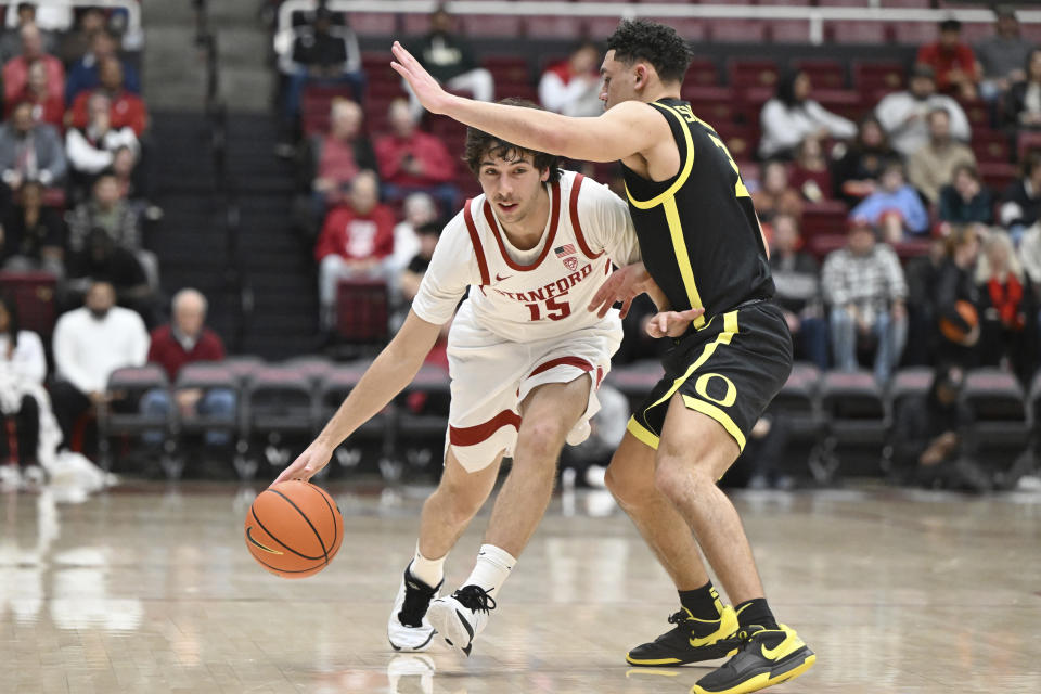 Stanford guard Benny Gealer (15) drives against Oregon guard Jackson Shelstad during the first half of an NCAA college basketball game Thursday, Feb. 22, 2024, in Stanford, Calif. (AP Photo/Nic Coury)