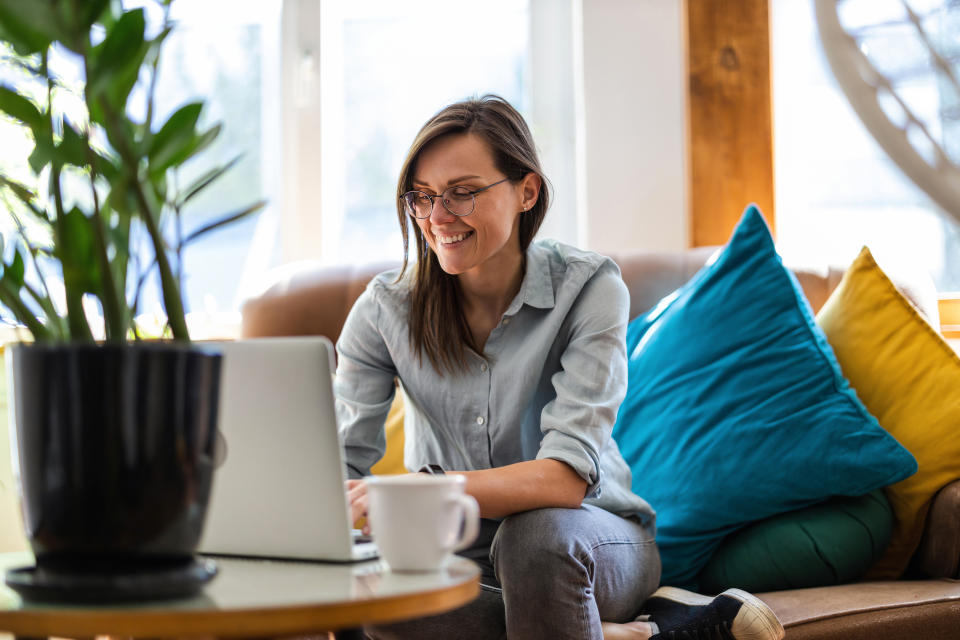 Young woman using a laptop at home flexible working