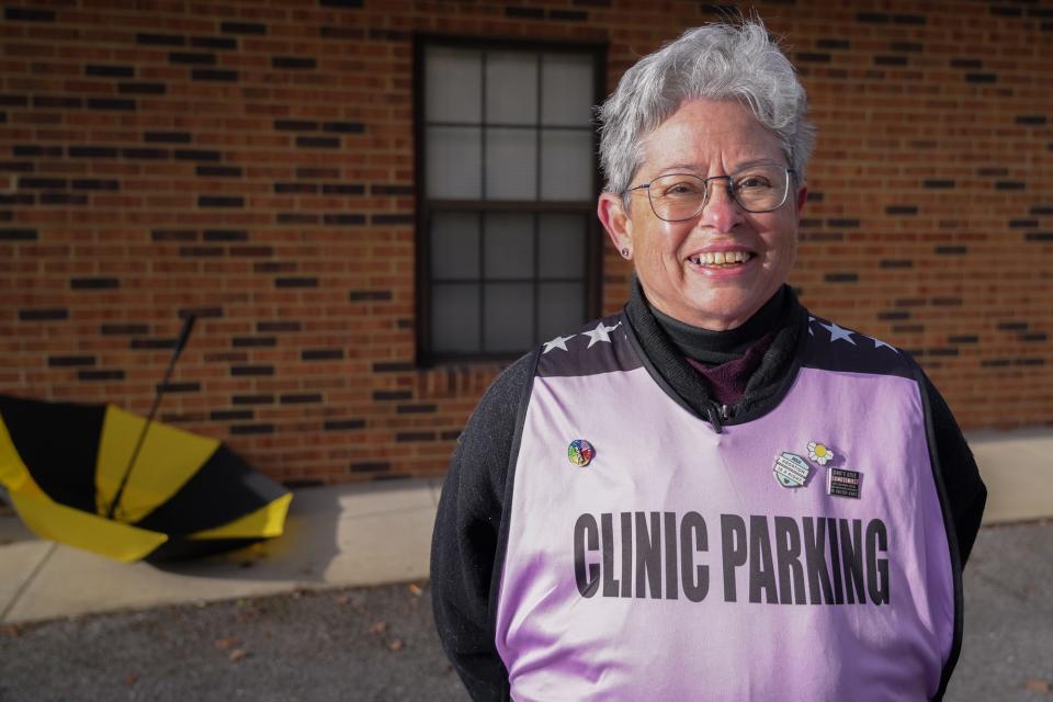 Barbara Schwartz, treasurer of the State Line Abortion Access Partners, poses outside Bristol Women's Health, where she volunteers as a patient escort. She uses an umbrella to shield patients from protesters across the street.