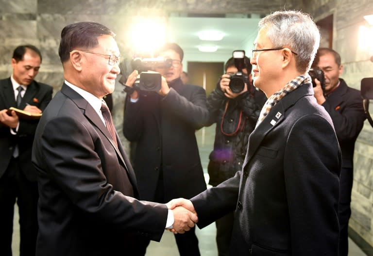 This handout photo provided by the South Korean Unification Ministry shows North Korea's chief delegate Kwon Hyok-Bong (L) greeting South Korea's chief delegate Lee Woo-Sung (R)