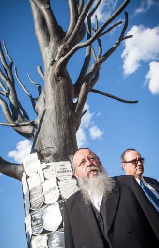 Israeli Minister of Education Menachem Eliezer Moses (L) and Israeli ambassador to Poland Zvi Rav-Ner (R) stand by the World War II prison Pawiak Monument as they take part in a march during ceremonies marking the 70th anniversary of the start of Nazi Germany's mass deportation of Jews from the Warsaw Ghetto to the death camp of Treblinka