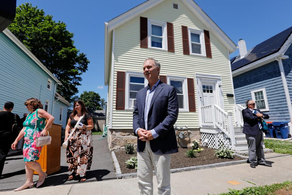 Mayor Jon Mitchell takes questions after an event announcing a first-time homebuyer program, held in front of a home on Newton Street in New Bedford which was purchased with the help of grants.