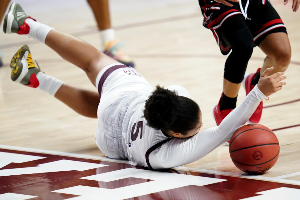 Texas A&M guard Jordan Nixon (5) dives for a loose ball against Lamar during the second half of an NCAA college basketball game Wednesday, Nov. 25, 2020, in College Station, Texas. (AP Photo/Sam Craft)