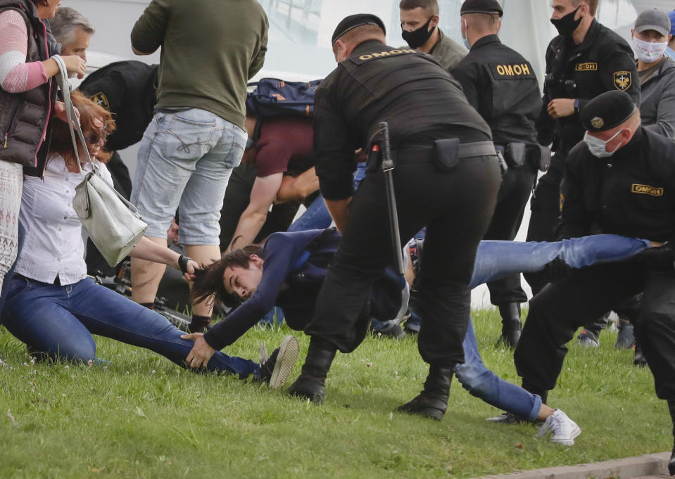 Police officers detain protesters during a rally against the removal of opposition candidates from the presidential elections in Minsk, Belarus, Tuesday, July 14, 2020. Election authorities in Belarus on Tuesday barred two main rivals of authoritarian leader Alexander Lukashenko from running in this summer's presidential election. (AP Photo/Sergei Grits)