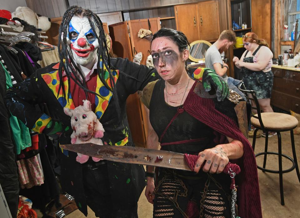 Eeriebyss scare actors Caleb Mohr, at left, dressed as Kinky the Clown, and makeup artist Julia Baldwin, at right, are shown, Oct. 8, 2021, in the makeup room at the Eeriebyss Factory of Terror 1053 W. 12th St. in Erie. Eeriebyss will open this year on the weekend of Sept. 30.