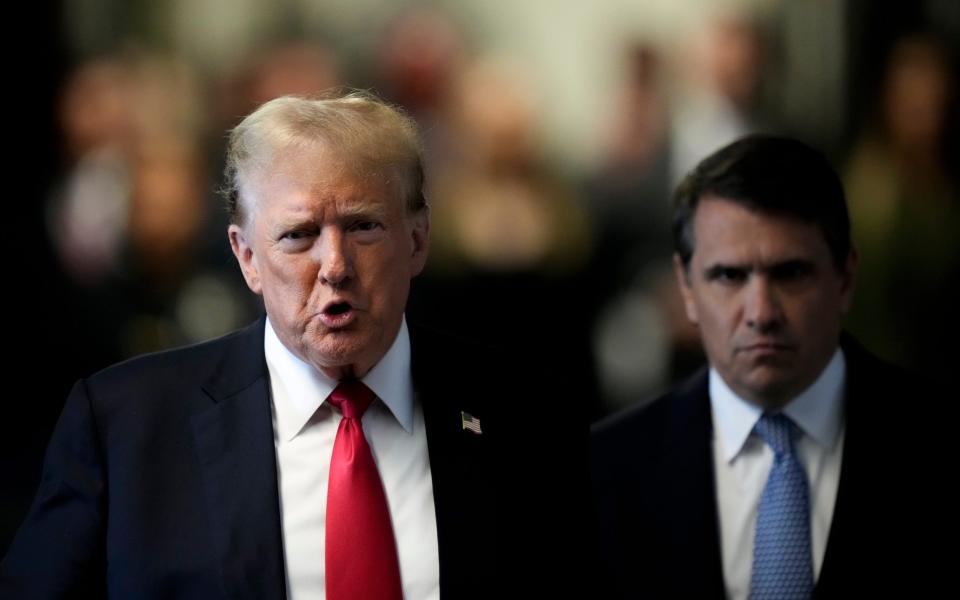 Former President Donald Trump speaks to members of the media upon arriving at Manhattan Criminal Court