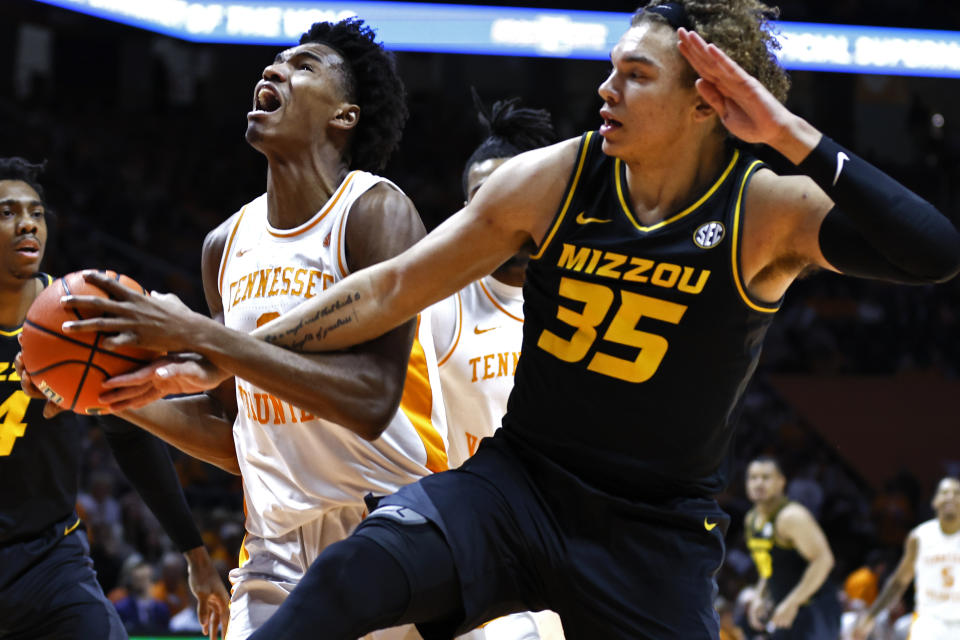 Tennessee forward Julian Phillips, front left,is fouled by Missouri forward Noah Carter (35) as he goes to shoot during the first half of an NCAA college basketball game Saturday, Feb. 11, 2023, in Knoxville, Tenn. (AP Photo/Wade Payne)