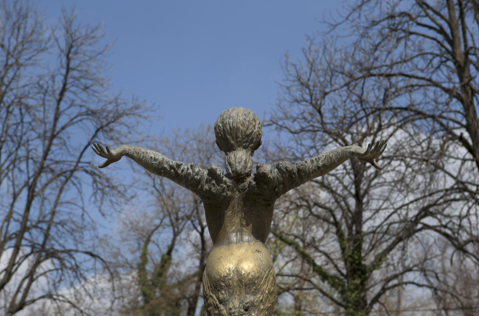 This April 10, 2013 photo shows a statue at the Bellu cemetery in Bucharest, Romania. It was founded by a shepherd, according to local legend, and was later nicknamed the Paris of the East. But Bucharest's idyllic roots and elegant reputation eventually gave way to a series of 20th century calamities: war, invasions, earthquakes and communism.(AP Photo/Vadim Ghirda)