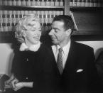 <p>Marilyn Monroe and Joe DiMaggio were wed in a spontaneous civil ceremony at the San Francisco courthouse. DiMaggio gives the Hollywood starlet a look of love as the two say "I do" in the low-key nuptials. </p>