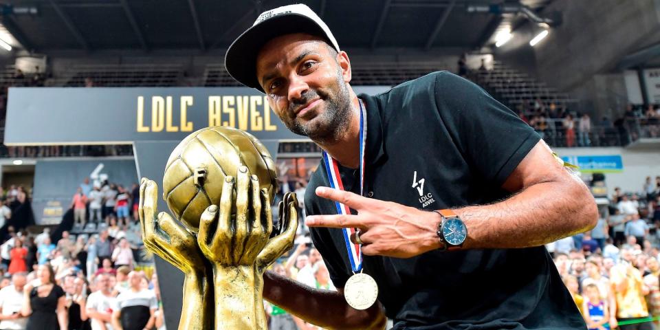 Tony Parker poses next to a championship trophy amid celebrations for his French pro team ASVEL