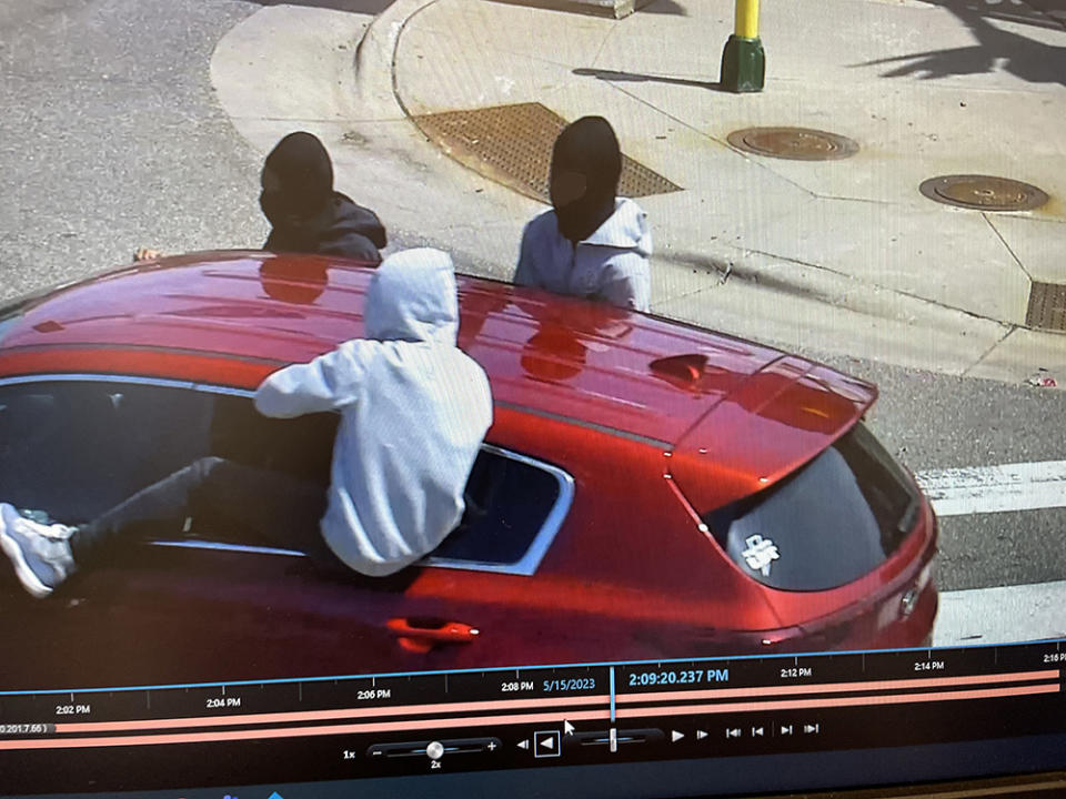 Surveillance camera footage captures three teens in a red Kia that Minneapolis police allege shot through a window at the school district headquarters. Police responded to the scene after ShotSpotter alerted officers of gunfire. (Minneapolis Police Department) 