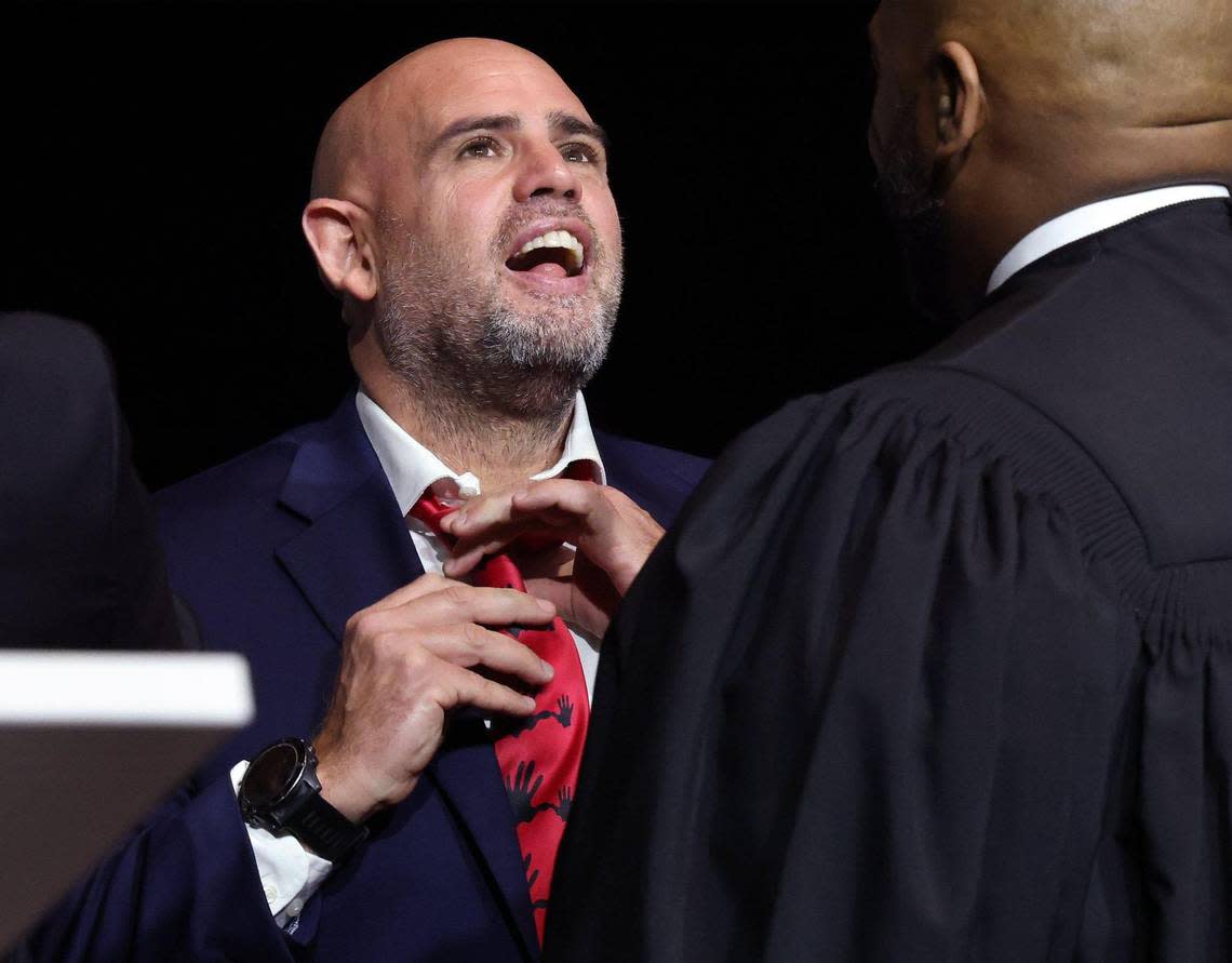 Consul General Israel Maor Elbaz-Starinsky adjusts his 5000 Role Models tie after being inducted into the organization as a mentor during the 5000 Role Models of Excellence 30th scholarship breakfast at the Miami Beach Convention Center on Monday, Jan. 16, 2023.