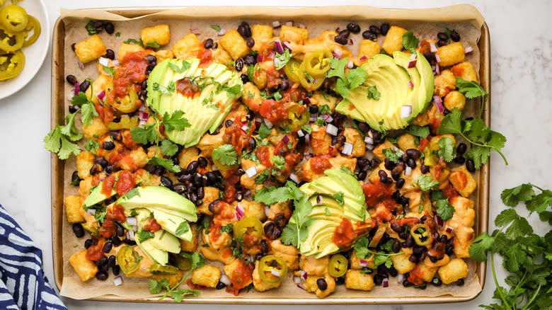 loaded tater tots on baking sheet