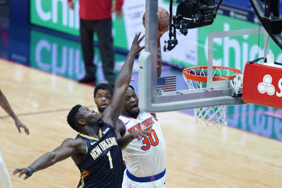 New York Knicks forward Julius Randle (30) goes to the basket against New Orleans Pelicans forward Zion Williamson (1) in the first half of an NBA basketball game in New Orleans, Wednesday, April 14, 2021. (AP Photo/Gerald Herbert)