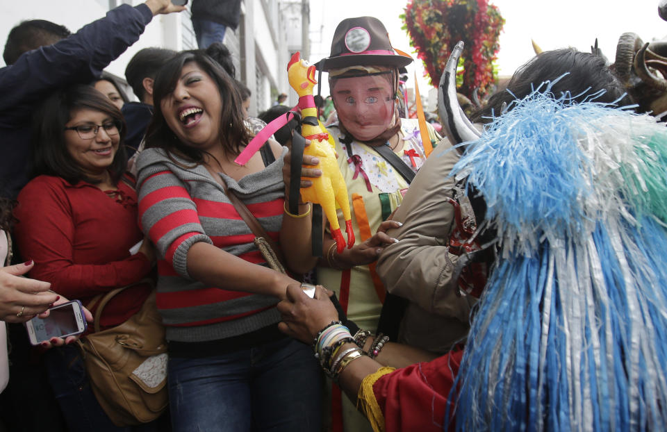 A woman refuses to dance with a devil during "La Diablada" festival in Pillaro, Ecuador, Friday, Jan. 6, 2017. Thousands of singing and dancing devils take over the mountain town in Ecuador for six days of revelry in the streets. (AP Photo/Dolores Ochoa)