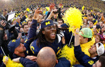 Denard Robinson of the Michigan Wolverines celebrates with students after beating Ohio State 40-34 at Michigan Stadium on November 26, 2011 in Ann Arbor, Michigan. (Photo by Gregory Shamus/Getty Images)
