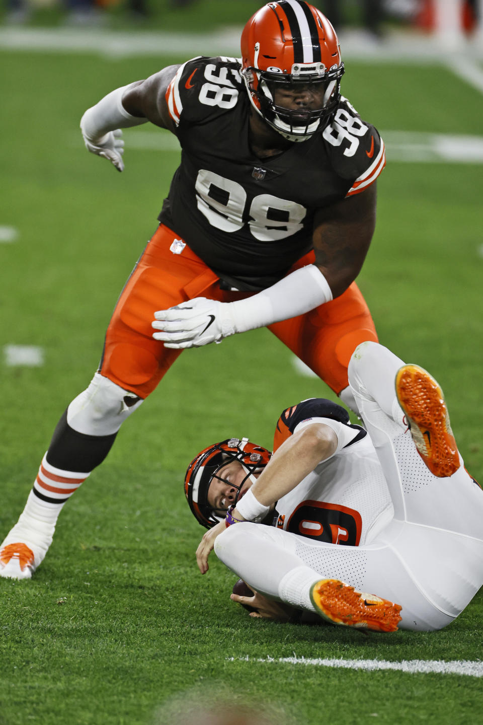 Cleveland Browns defensive tackle Sheldon Richardson (98) sacks Cincinnati Bengals quarterback Joe Burrow during the first half of an NFL football game Thursday, Sept. 17, 2020, in Cleveland. (AP Photo/Ron Schwane)