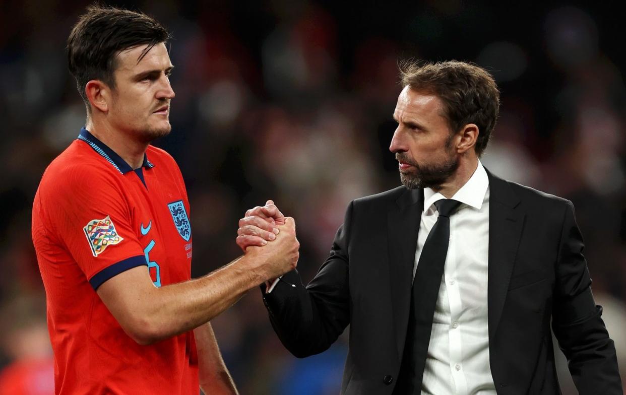 Harry Maguire (left) and Gareth Southgate - Harry Maguire waited behind for two hours after Germany draw to talk with Gareth Southgate - GETTY IMAGES