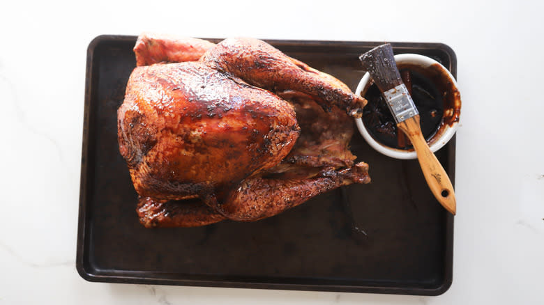 Glazed smoked turkey resting on sheet tray