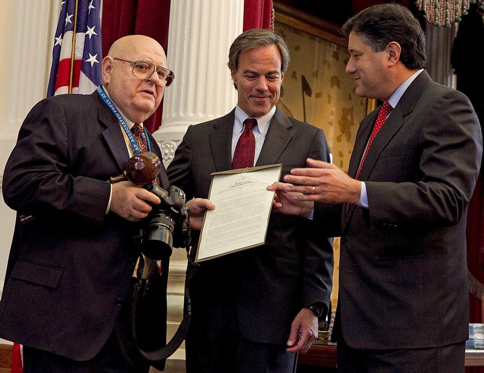 Retired Associated Press photographer Harry Cabluck, left, receives a commendation from Texas House Speaker Joe Straus, center, and state Rep. Richard Peña Raymond on May 11, 2011. Cabluck was honored with a House resolution for 50 years of photojournalism. As an AP photographer based in Austin, Cabluck covered numerous sessions of the Legislature.