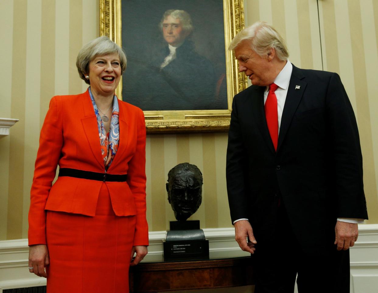 President Trump looks at Churchill bust while meeting with British Prime Minister May at the White House earlier this year: Reuters
