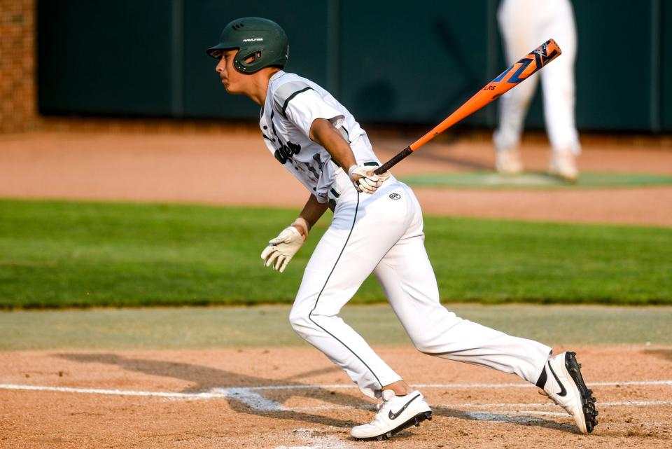 Olivet's Lalo Aguirre gets a hit against Grand Ledge in the first inning on Monday, June 5, 2023, at McLane Stadium on the Michigan State University campus in East Lansing.