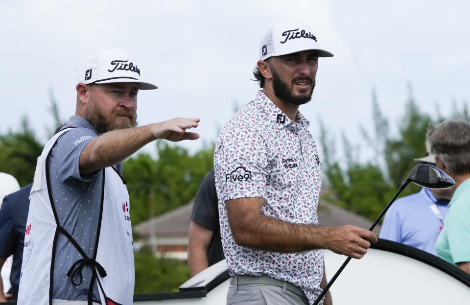 Max Homa, of the United States, right, consults with his caddie on a tee shot during the first round of the Hero World Challenge PGA Tour at the Albany Golf Club, in New Providence, Bahamas, Thursday, Dec. 1, 2022. (AP Photo/Fernando Llano)